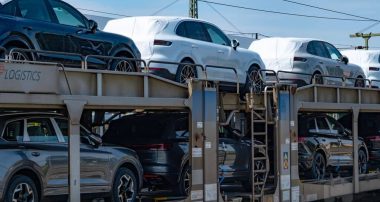 Freight train transporting convoy brand-new Porsche macan